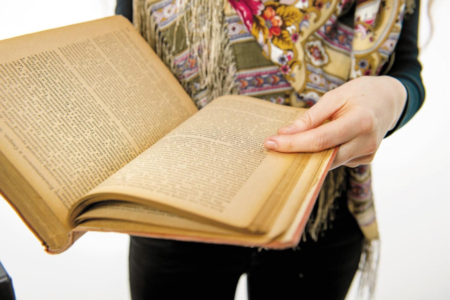 Person holding an open book